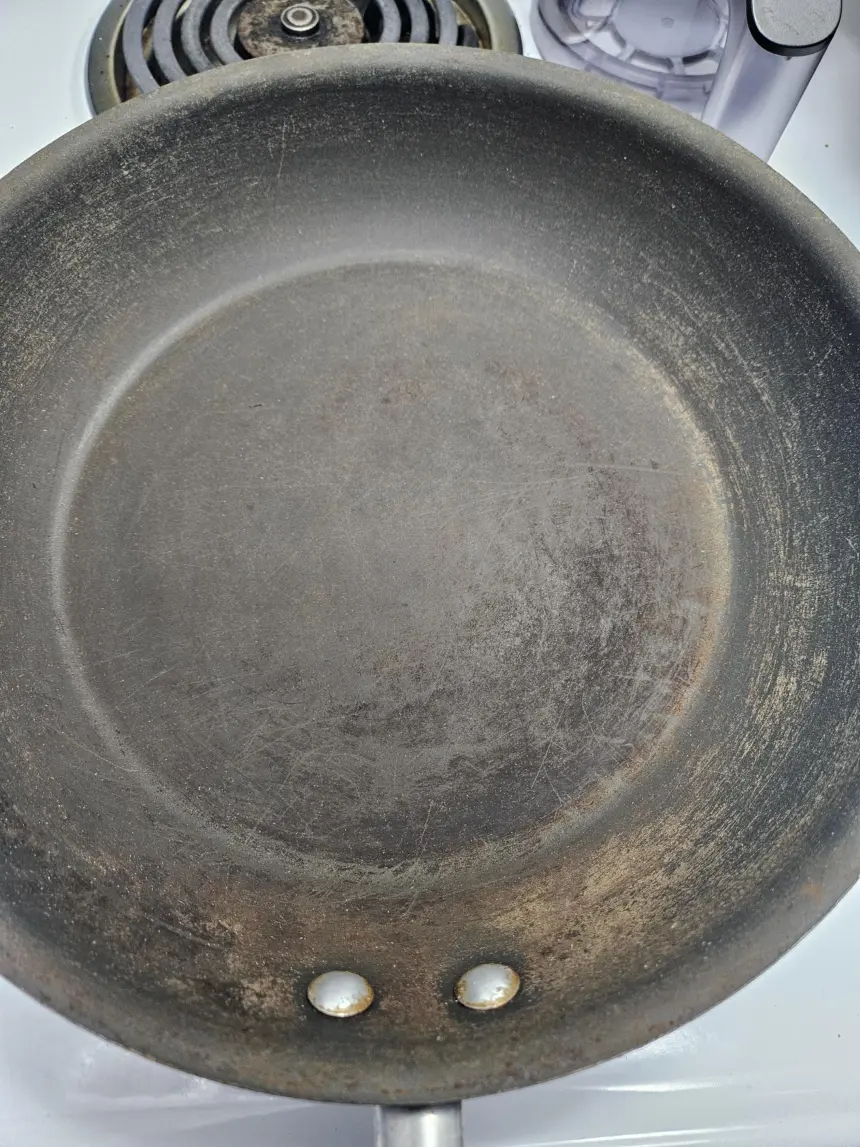 How to restore this pan, it accidentally got thrown into the dishwasher and now it looks rusted. What can I do?